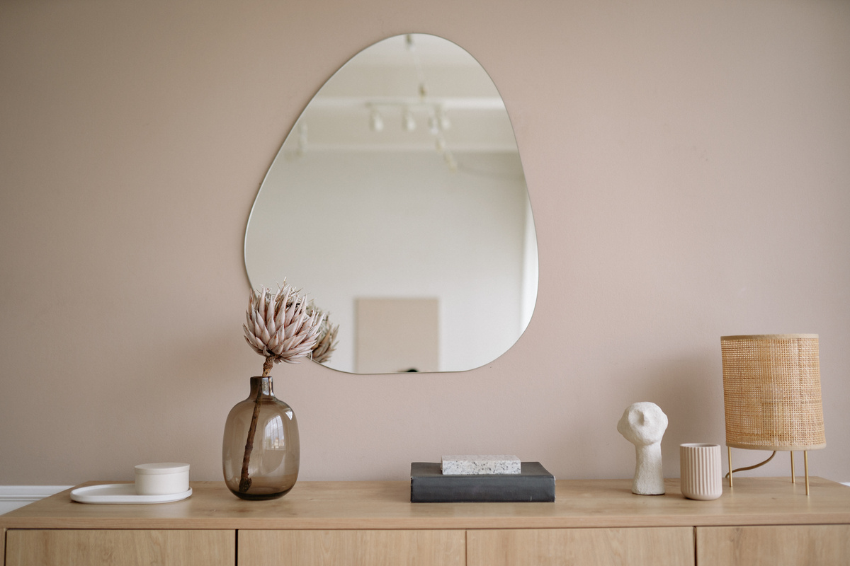 A Mirror Wall Above a Cabinet