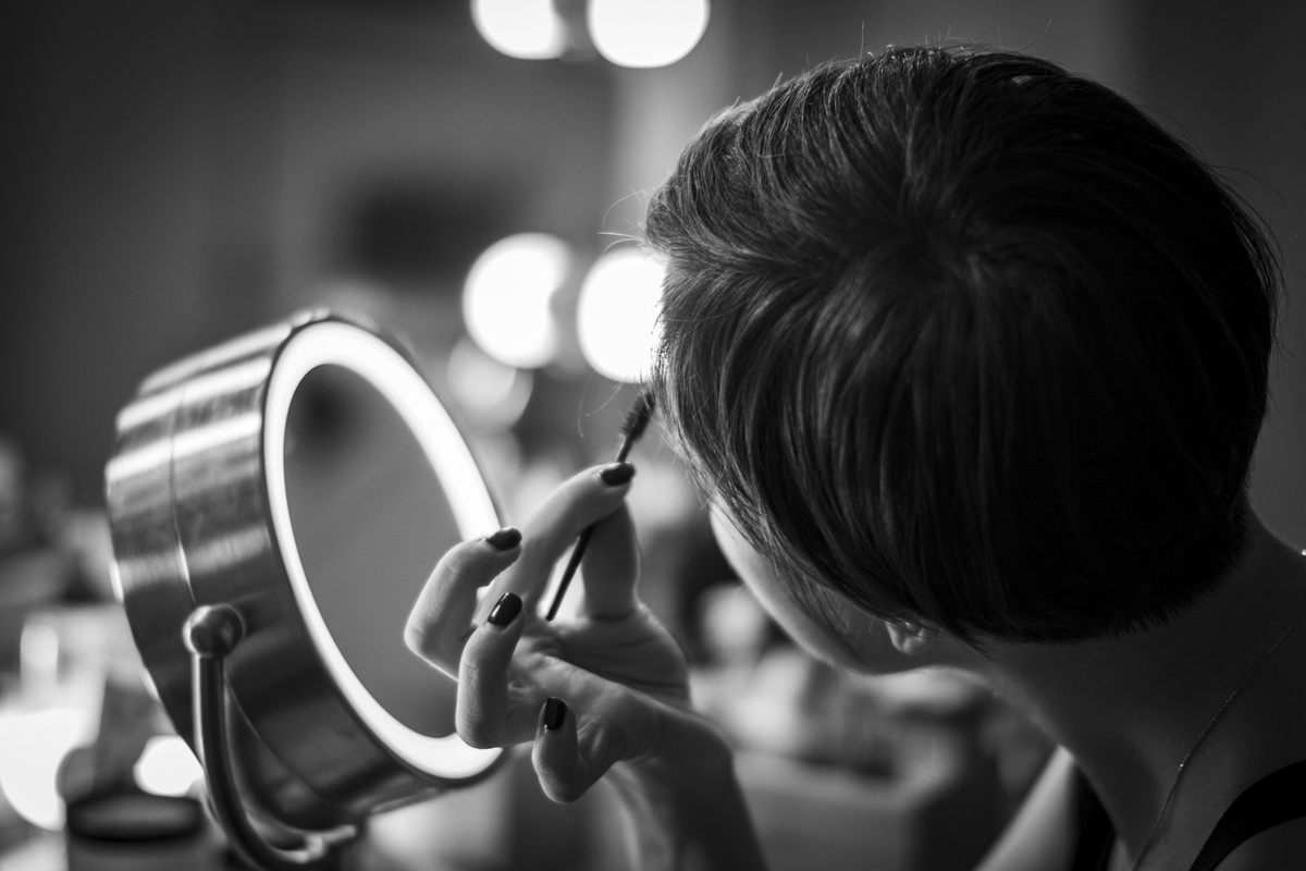 Grayscale Photo of Person Applying a Make-Up