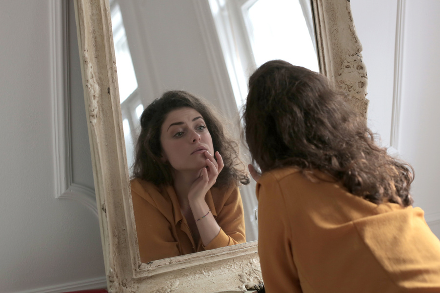 Woman in Yellow Long Sleeve Shirt in Front of a Mirror